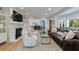 Spacious living room with fireplace, hardwood floors, and seamless flow into the kitchen and dining area at 2840 Alpine Rd, Atlanta, GA 30305