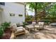 Outdoor patio area with stone flooring, outdoor seating, and a view of the landscaped backyard at 2840 Alpine Rd, Atlanta, GA 30305
