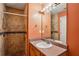 Bathroom with tiled shower, vanity with mirror and neutral countertop at 5679 Windfall Ln, Lithonia, GA 30058