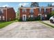 Inviting townhome with classic brick facade, well-maintained landscaping, and convenient parking at 5679 Windfall Ln, Lithonia, GA 30058
