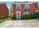 Charming brick townhome featuring a neatly landscaped front yard and private parking at 5679 Windfall Ln, Lithonia, GA 30058