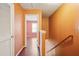 Hallway with wood railing on the stairs, and view to a bedroom with natural light at 5679 Windfall Ln, Lithonia, GA 30058