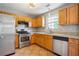 Well-lit kitchen with stainless steel appliances, light wood cabinets, and neutral countertops at 5679 Windfall Ln, Lithonia, GA 30058