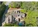 Aerial view of a luxurious estate with a private pool and lush green landscaping at 105 Kingston Mnr, Atlanta, GA 30342