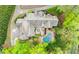 Expansive home with a backyard oasis featuring a private pool, lush landscaping, and a serene courtyard at 105 Kingston Mnr, Atlanta, GA 30342
