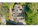 Expansive property aerial with lush greenery, pool, fountain, and shingle roof at 105 Kingston Mnr, Atlanta, GA 30342
