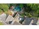 Lush landscaped backyard aerial featuring a pool, spa, and stone patio at 105 Kingston Mnr, Atlanta, GA 30342