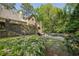 Stone steps lead to a pool and the backyard is surrounded by lush landscaping at 105 Kingston Mnr, Atlanta, GA 30342