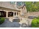 Backyard with a brick patio, a fountain with a statue, grill, and outdoor seating at 105 Kingston Mnr, Atlanta, GA 30342