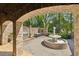 Charming patio area with a fountain, outdoor grill, and brick archways at 105 Kingston Mnr, Atlanta, GA 30342