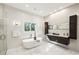 Bright bathroom features a soaking tub, glass shower, modern vanity with double sinks and elegant fixtures at 105 Kingston Mnr, Atlanta, GA 30342