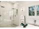 Modern bathroom showcasing a glass-enclosed shower, soaking tub, and sleek fixtures, offering a spa-like experience at 105 Kingston Mnr, Atlanta, GA 30342