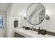 Bright bathroom featuring a round mirror and modern fixtures at 105 Kingston Mnr, Atlanta, GA 30342