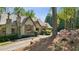 Quaint stone home with a stone chimney and lovely azalea bushes at 105 Kingston Mnr, Atlanta, GA 30342