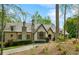 Charming home with a combination of stone and brick, featuring a distinctive roofline and shuttered windows at 105 Kingston Mnr, Atlanta, GA 30342