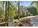 Charming stone home entrance with beautiful azaleas and mature trees at 105 Kingston Mnr, Atlanta, GA 30342
