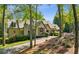Picturesque home showcasing a blend of stone and brick, surrounded by mature trees and flowering bushes at 105 Kingston Mnr, Atlanta, GA 30342