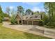 View of the exterior showcasing a three-car garage and sprawling driveway at 105 Kingston Mnr, Atlanta, GA 30342