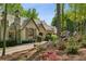 Charming stone home featuring a shake roof, chimney, and lovely landscaping at 105 Kingston Mnr, Atlanta, GA 30342