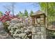Stone pillar with lantern and lush landscaping featuring blooming azaleas at 105 Kingston Mnr, Atlanta, GA 30342