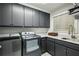 Laundry room with gray cabinets, a white countertop, a sink, and a washer and dryer at 105 Kingston Mnr, Atlanta, GA 30342