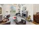 Cozy living room featuring a black fireplace, grand piano, large window, and hardwood floors with area rug at 105 Kingston Mnr, Atlanta, GA 30342