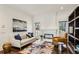 Inviting living room with large windows, a cozy fireplace, and comfortable seating with bright natural lighting at 105 Kingston Mnr, Atlanta, GA 30342