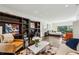 Spacious living room with built-in shelving, seating, and view to a bedroom, providing an inviting and open space at 105 Kingston Mnr, Atlanta, GA 30342