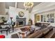 This comfortable living room includes a fireplace, black grand piano, hardwood floors, and gray vaulted ceilings at 105 Kingston Mnr, Atlanta, GA 30342