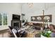 Bright living room boasts a modern fireplace, large TV, plush seating, and ample natural light from a large window at 105 Kingston Mnr, Atlanta, GA 30342