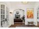 Open living room view into the dining room with arched entryway and brick floors at 105 Kingston Mnr, Atlanta, GA 30342