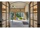 Covered patio with brick floors, a fountain and outdoor seating as seen through a doorway at 105 Kingston Mnr, Atlanta, GA 30342