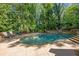 Inviting backyard pool with a slide, waterfall, and ample seating at 105 Kingston Mnr, Atlanta, GA 30342