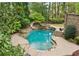 Landscaped backyard featuring a custom pool with a slide and waterfall at 105 Kingston Mnr, Atlanta, GA 30342