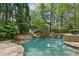 Freeform pool with rock accents, slide, hot tub, and plenty of room for entertaining at 105 Kingston Mnr, Atlanta, GA 30342