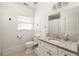Bright bathroom with beadboard walls, granite countertop, and patterned floors at 27 Spence Ne Ave, Atlanta, GA 30317