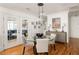 Elegant dining area with glass table, modern lighting, and view to outdoor porch at 27 Spence Ne Ave, Atlanta, GA 30317