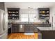 Bright kitchen with stainless appliances, granite counters, open shelving, and hardwood floors at 27 Spence Ne Ave, Atlanta, GA 30317
