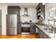 Updated kitchen featuring stainless steel appliances, granite counters, subway tile, and hardwood floors at 27 Spence Ne Ave, Atlanta, GA 30317