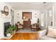 Elegant living room with hardwood floors, a cozy fireplace, and comfortable seating, perfect for relaxation and entertaining at 27 Spence Ne Ave, Atlanta, GA 30317