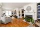 Bright, open-concept living room with hardwood floors, fireplace, and large windows, perfect for entertaining guests at 27 Spence Ne Ave, Atlanta, GA 30317