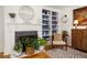 Cozy living room with a fireplace, built-in shelving, and stylish decor, creating a warm and inviting atmosphere at 27 Spence Ne Ave, Atlanta, GA 30317