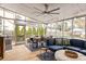 Inviting screened porch features a seating area, dining table and fan at 27 Spence Ne Ave, Atlanta, GA 30317