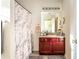 Bright bathroom with a sink and vanity, a decorative mirror, and a shower and tub combination at 4924 Antelope Cv, Atlanta, GA 30349