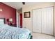 Comfortable bedroom features a closet with bi-fold doors and a large window at 4924 Antelope Cv, Atlanta, GA 30349