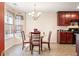 Bright breakfast nook features a modern chandelier and cheery windows with decorative curtains at 4924 Antelope Cv, Atlanta, GA 30349