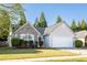 Charming single-story home with stone accents, manicured lawn, and attached two car garage on a sunny day at 4924 Antelope Cv, Atlanta, GA 30349