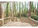 Inviting back deck showcasing a lush, green wooded view with a stairway leading down to the yard at 5000 Northland Sw Rd, Mableton, GA 30126