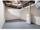 Unfinished basement showing ductwork, a water heater, and concrete floor at 5000 Northland Sw Rd, Mableton, GA 30126
