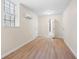 Basement with light laminate flooring, a window, mini split, and two doors, one leading to the bathroom at 5000 Northland Sw Rd, Mableton, GA 30126